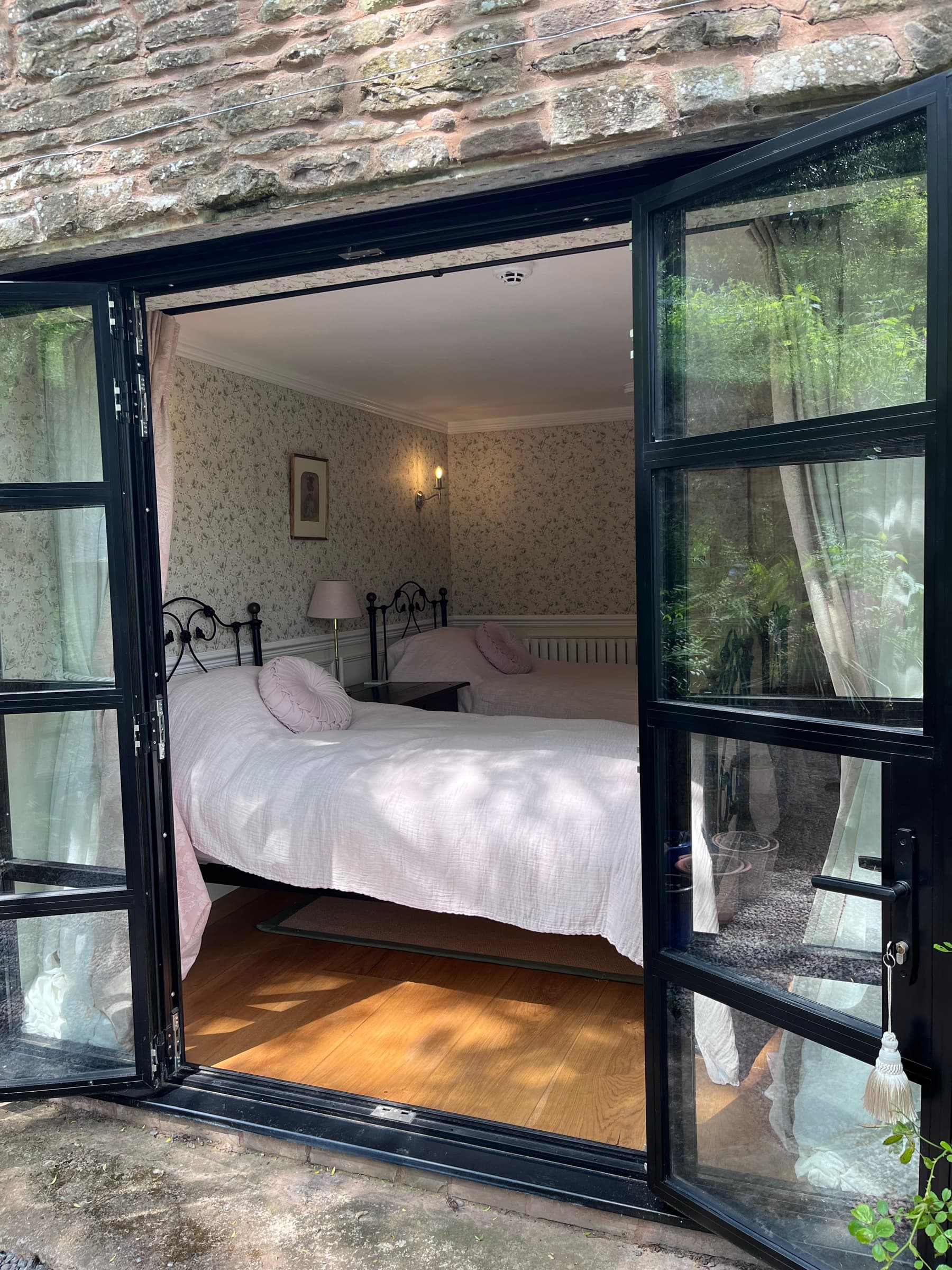 The bedroom at Ruthlin — white linen and garden light