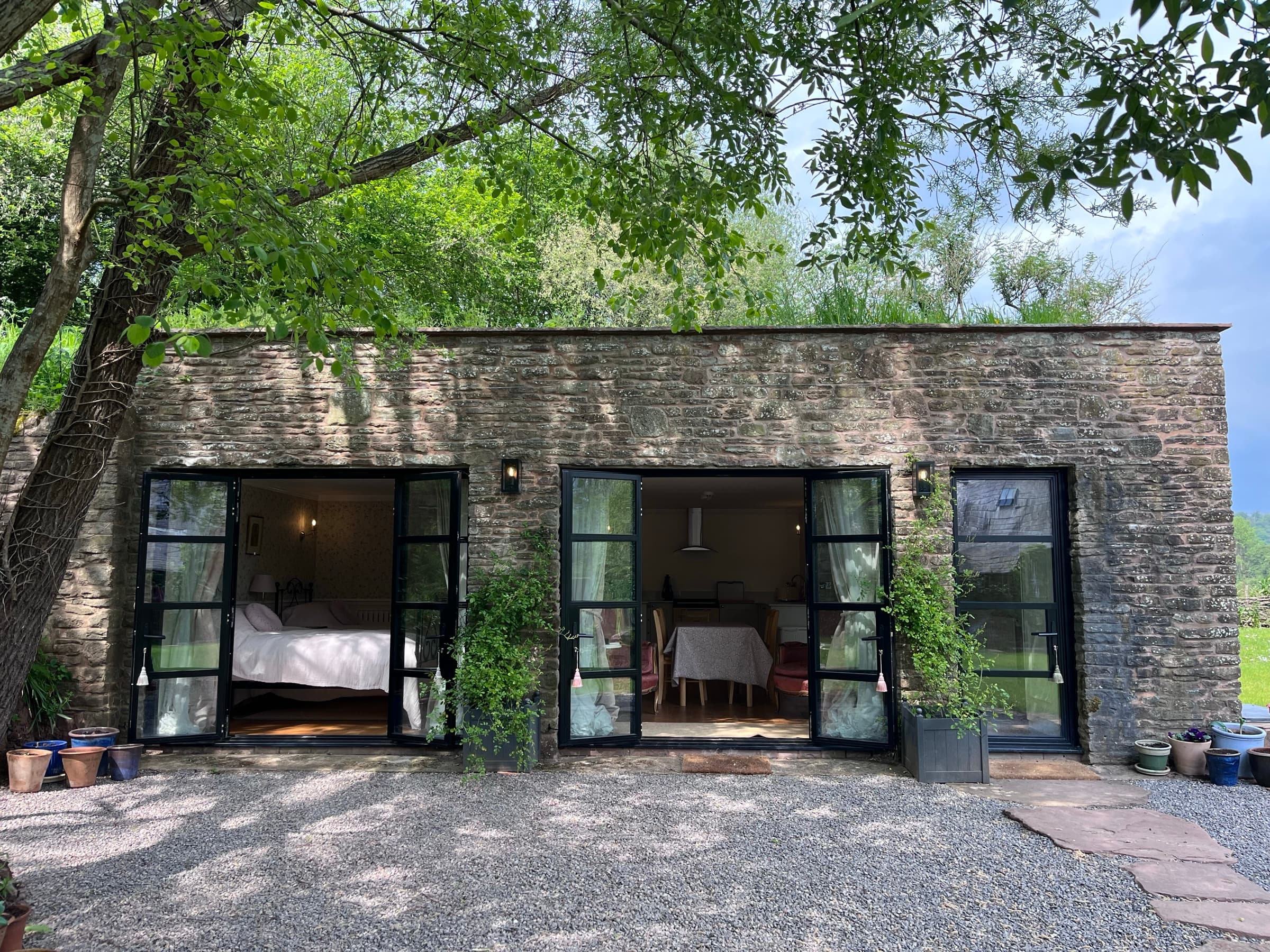 Ruthlin's glazed steel doors open onto the gravel courtyard, the valley and hills beyond