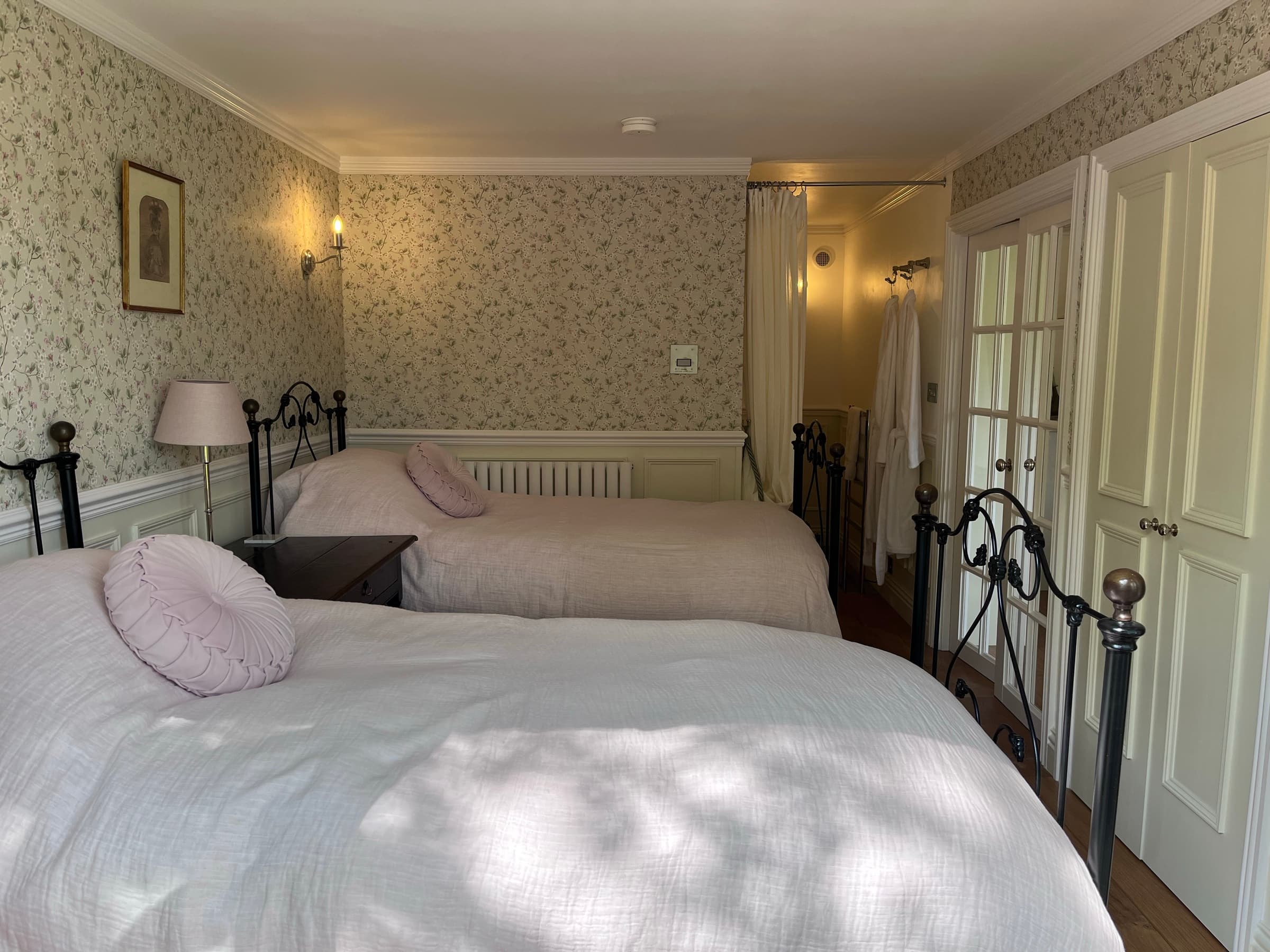The bedroom at Ruthlin — white linen and garden light