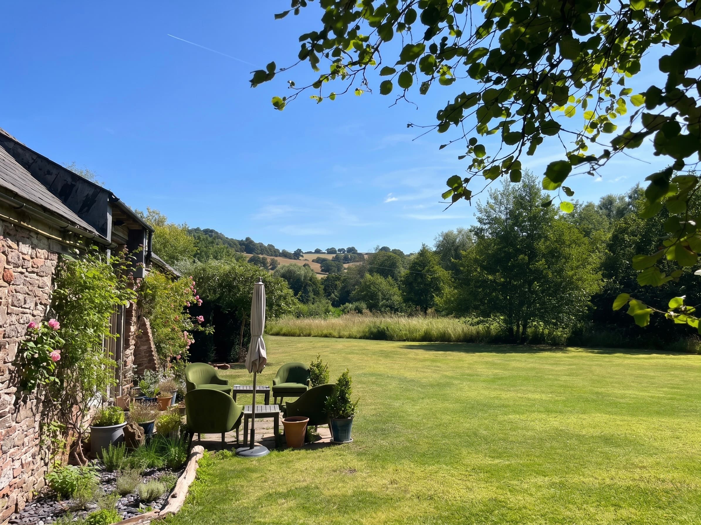 The grounds at Ruthlin — garden, woodland and the Welsh hills beyond