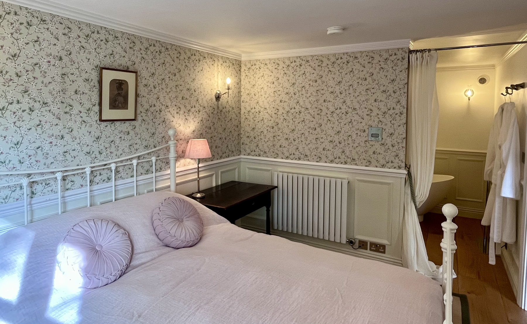 The double bedroom of Ruthlin’s luxury accommodation in Skenfrith, looking through to the bathroom