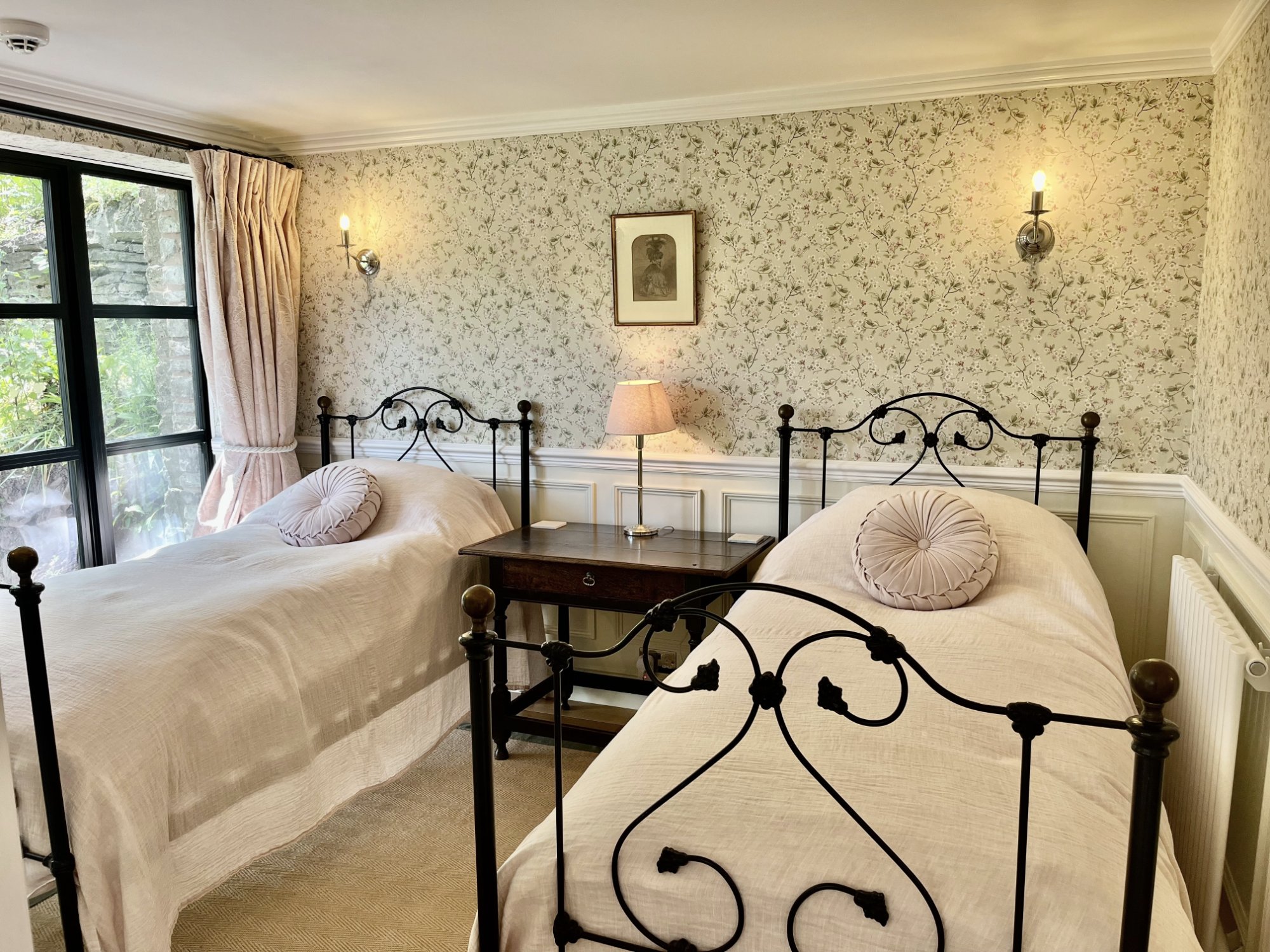 The bedroom at Ruthlin — white linen and garden light