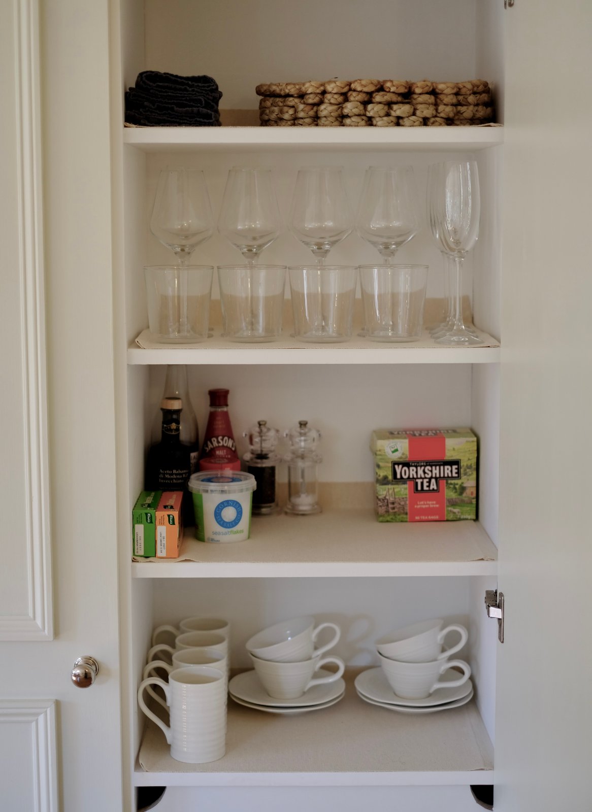 The cupboard at Ruthlin, stocked with glassware, tea and kitchen essentials